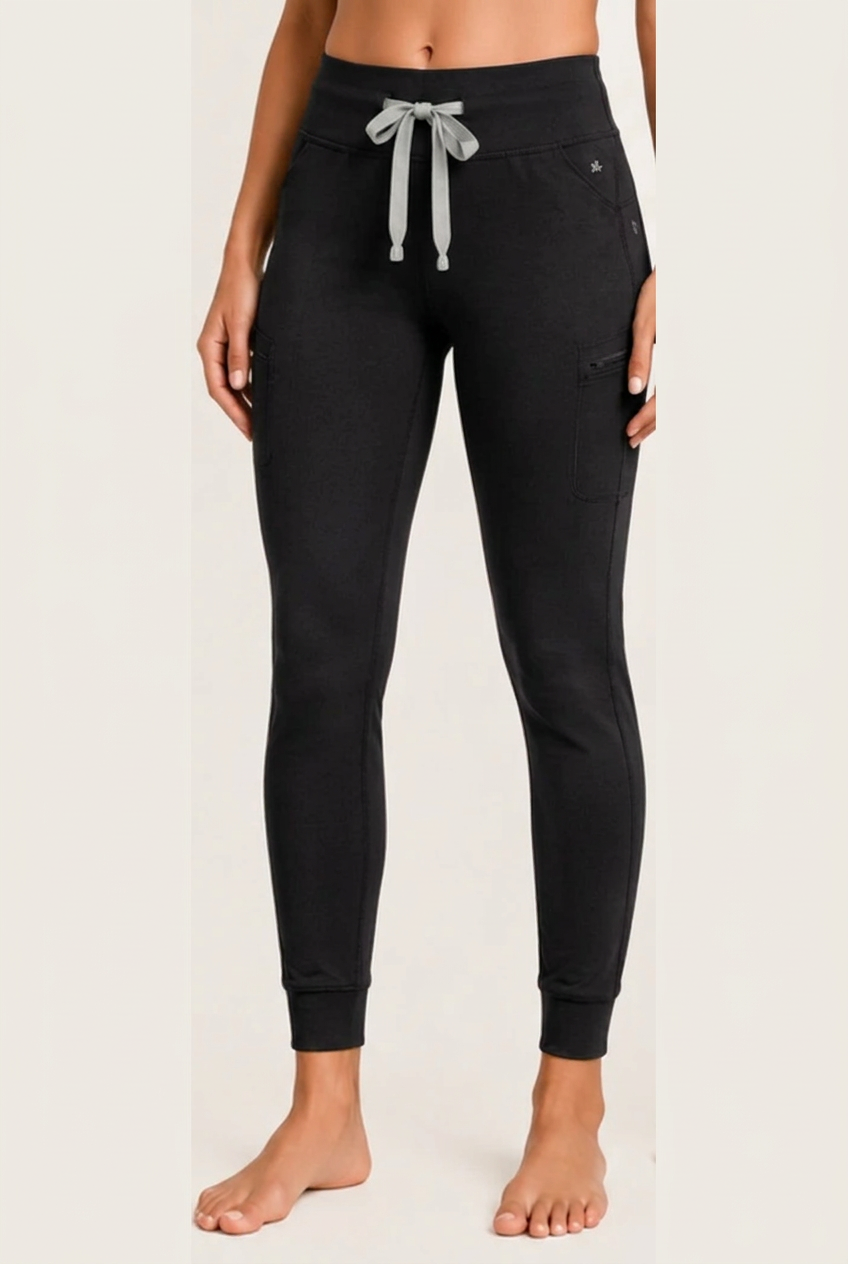 The Clover Legging in Black — high yoga-style waistband, contrasting drawstring, zip thigh pocket and cuffed ankle