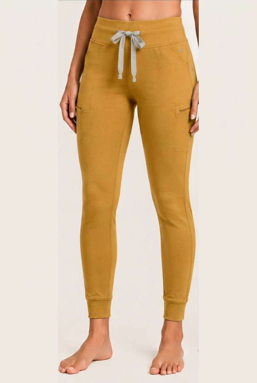 The Clover Legging in Mustard Yellow — high yoga-style waistband, contrasting drawstring, zip thigh pocket and cuffed ankle