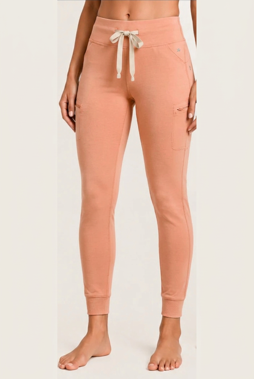 The Clover Legging in Peach — high yoga-style waistband, contrasting drawstring, zip thigh pocket and cuffed ankle