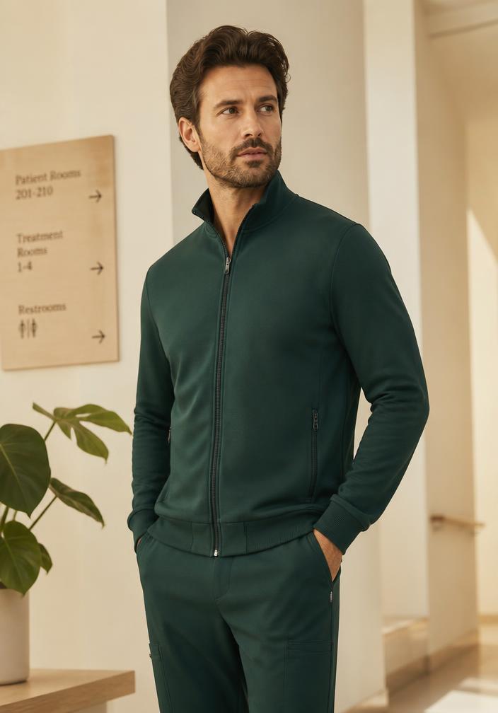 Man wearing a Clover green layer in warm natural light